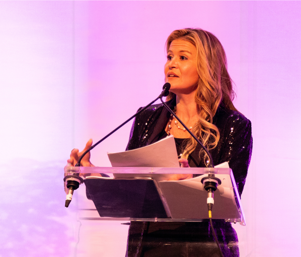 A woman speaking at a podium