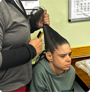 A woman having her hair combed